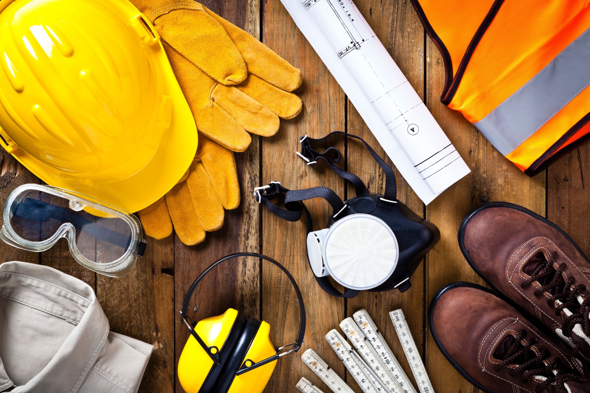 Personal safety workwear and construction blueprint shot directly above